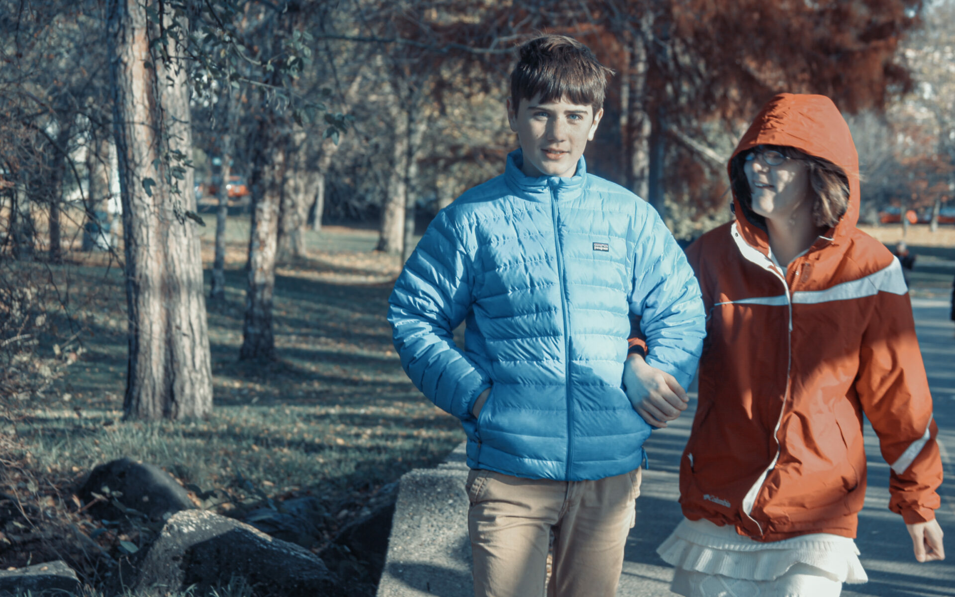 Two kids walking in a park